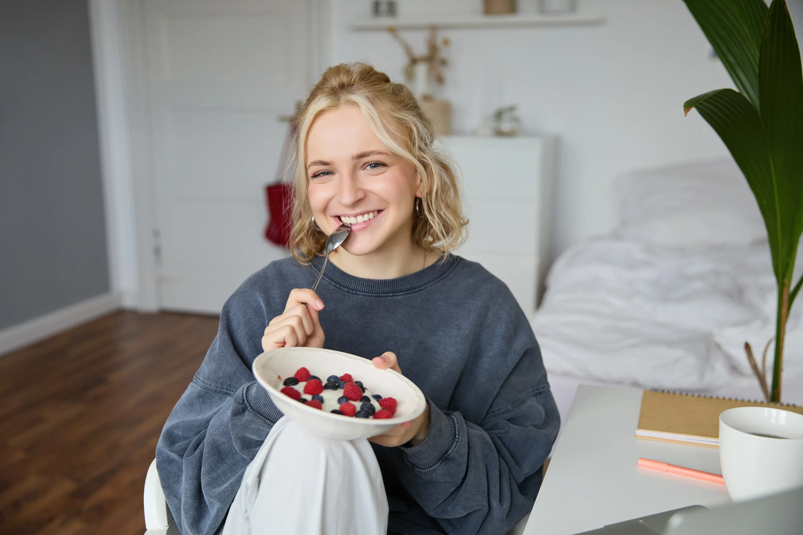 Colorful berry smoothie bowl topped with homemade granola, fresh berries, and a drizzle of honey