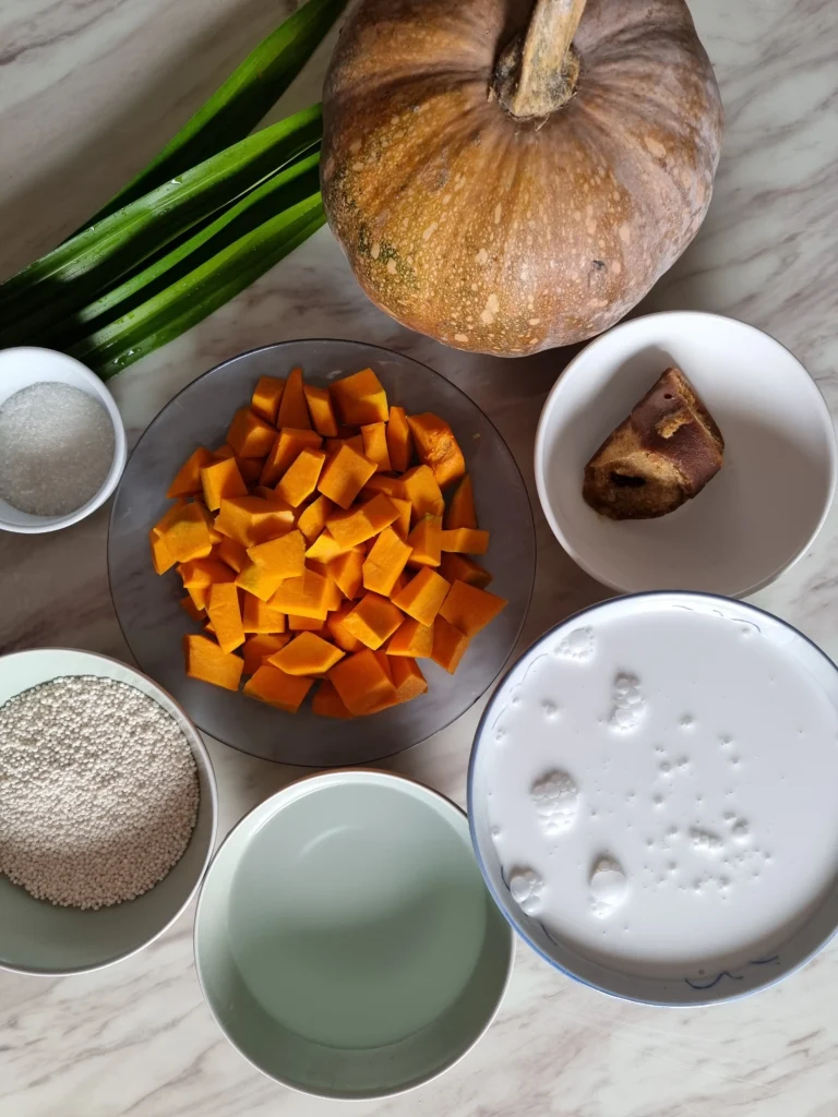 Creamy butternut squash and chickpea soup served in a bowl, garnished with fresh herbs
