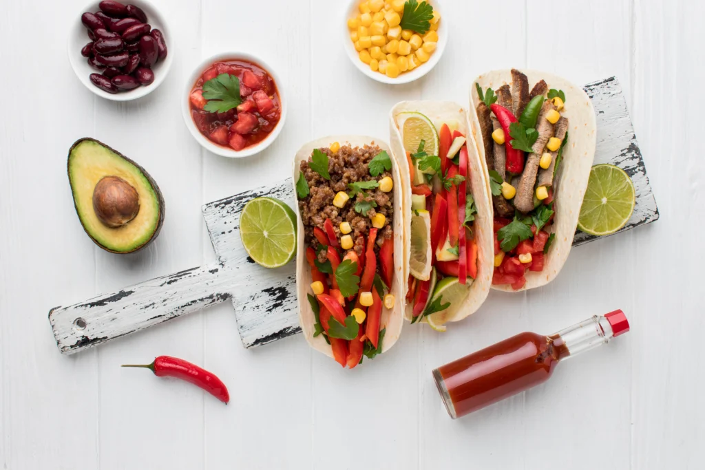 Grilled fish tacos topped with fresh avocado salsa, served on a plate
