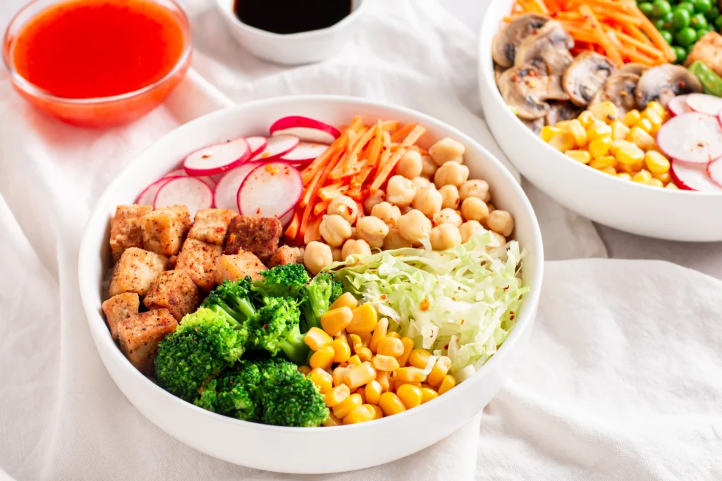 Delicious crispy chickpea and veggie bowl with quinoa, roasted vegetables, and tahini dressing