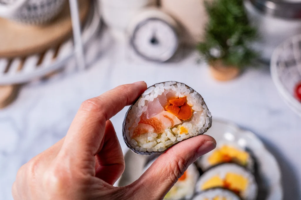 Keto-friendly rice sushi rolls made with cauliflower rice, avocado, cucumber, and nori, served fresh as a healthy low-carb sushi alternative.