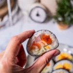 Keto-friendly rice sushi rolls made with cauliflower rice, avocado, cucumber, and nori, served fresh as a healthy low-carb sushi alternative.
