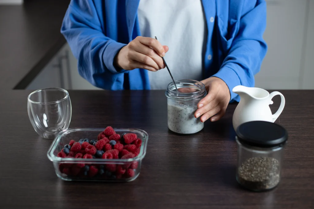 Overnight Oat Chia Parfait layered with Greek yogurt, fresh berries, chia seeds, and granola in a glass jar.
