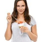 Overnight Oat Chia Parfait layered with Greek yogurt, fresh berries, chia seeds, and granola in a glass jar.