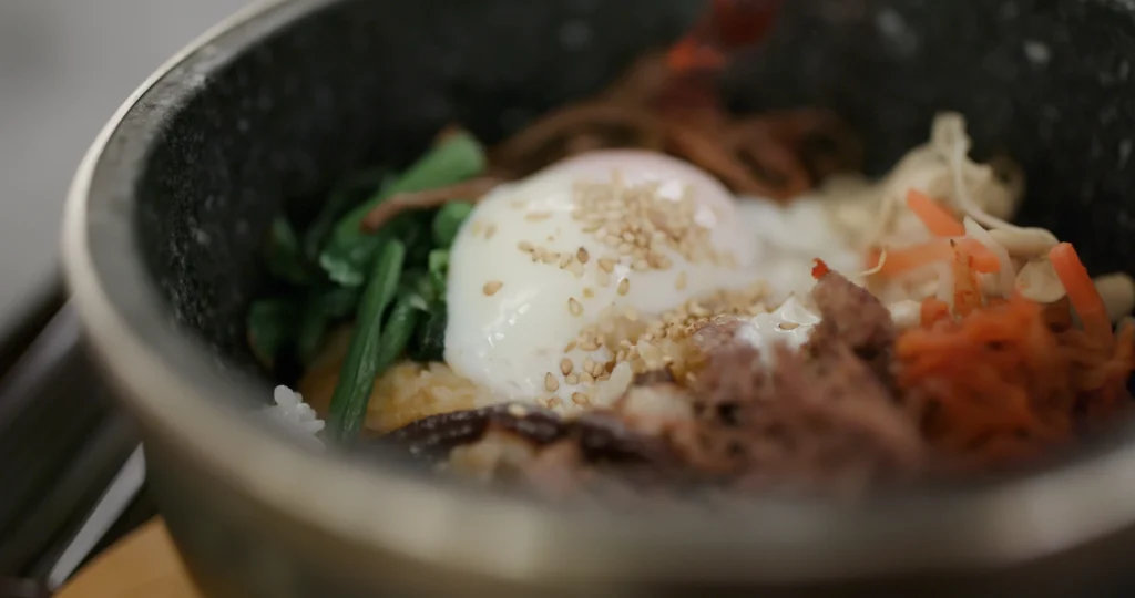 Delicious homemade Korean Tofu Bibimbap served in a bowl with crispy tofu, sautéed vegetables, and gochujang sauce