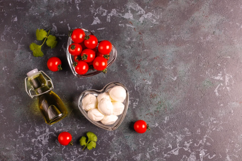 Heart-themed Valentine’s Day mini Caprese skewers with cherry tomatoes, mozzarella balls, and fresh basil arranged on a festive platter