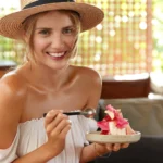 Layered strawberry tiramisu with mascarpone cream and fresh strawberries in a glass dish