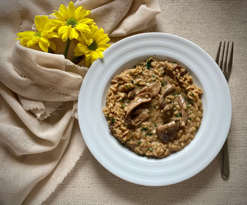 Creamy truffle mushroom risotto served in a white bowl, garnished with parmesan and fresh thyme for a romantic Valentine’s Day dinner at home.