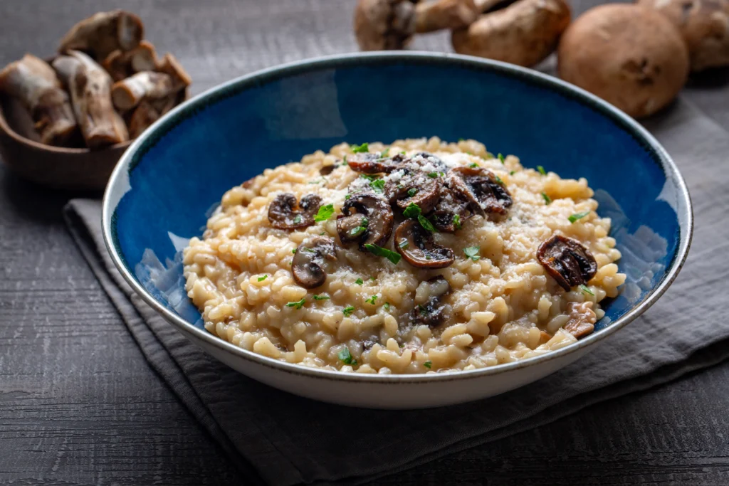 Creamy truffle mushroom risotto served in a white bowl, garnished with parmesan and fresh thyme for a romantic Valentine’s Day dinner at home.