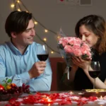 A romantic Valentine’s Day berry mocktail in a heart-shaped glass, garnished with fresh strawberries, raspberries, and mint leaves on a festive pink table setting.