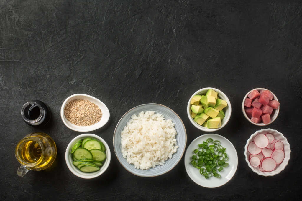 Keto-friendly rice sushi rolls made with cauliflower rice, avocado, cucumber, and nori, served fresh as a healthy low-carb sushi alternative.