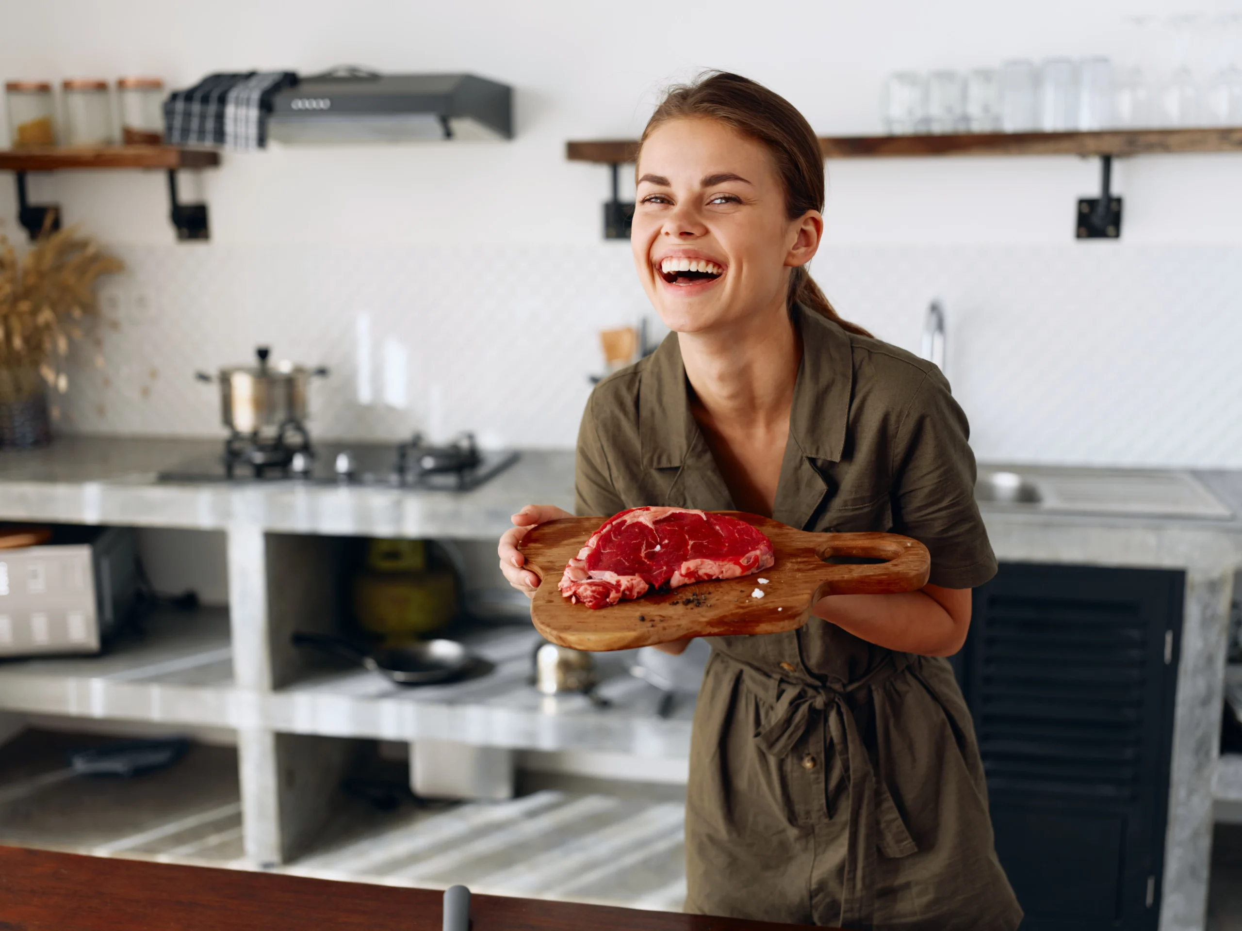 Juicy steak with peppercorn cream sauce sliced on a plate with creamy sauce and fresh cracked pepper on top