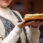 Homemade pizzelle cookies on a plate made with a foolproof pizzelle recipe for beginners