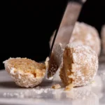 Homemade peanut butter balls coated in chocolate on a plate