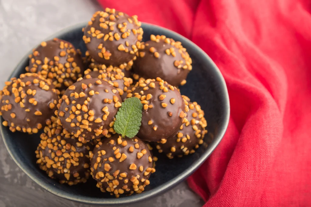 Homemade peanut butter balls coated in chocolate on a plate