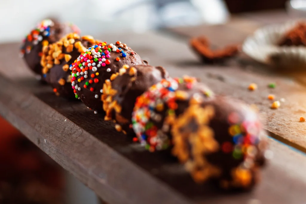 Homemade peanut butter balls coated in chocolate on a plate