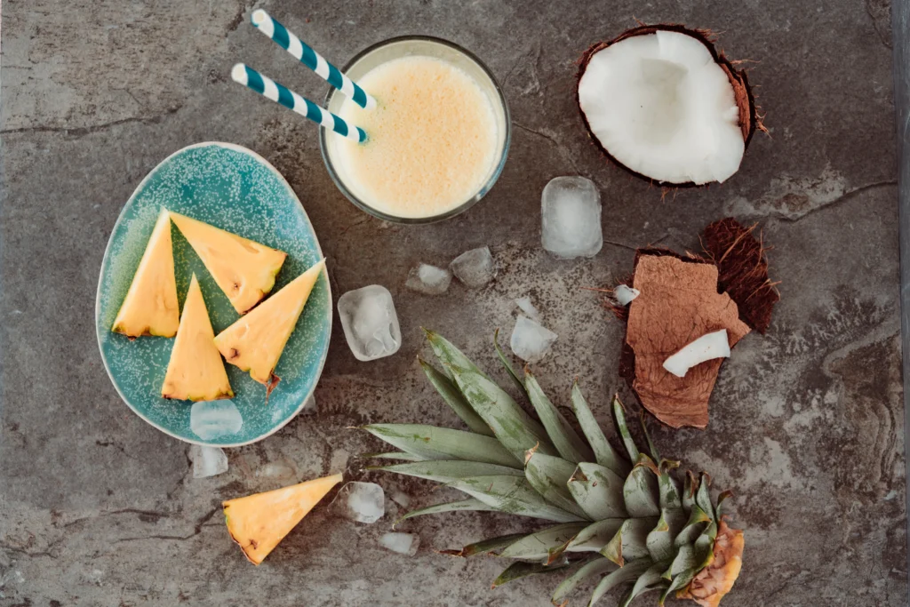 A glass of sweet, fruity Painkiller cocktail with tropical fruit garnish, ready to serve