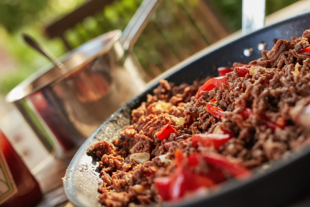 Ground beef and rice recipe served in a bowl with vegetables and herbs, a hearty homemade family dinner