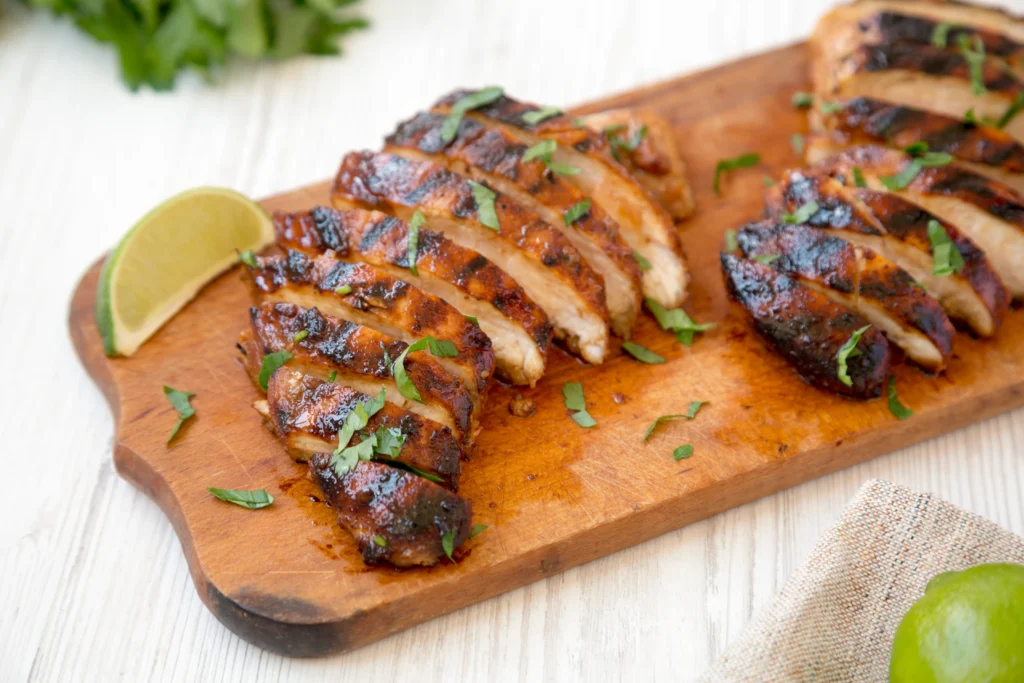 Smoky chipotle chicken served on a plate with lime and fresh herbs for a spicy dinner recipe