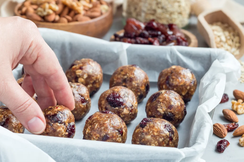 Healthy protein balls made with oats, nut butter, and protein powder, arranged on a plate for meal prep and fitness snacks