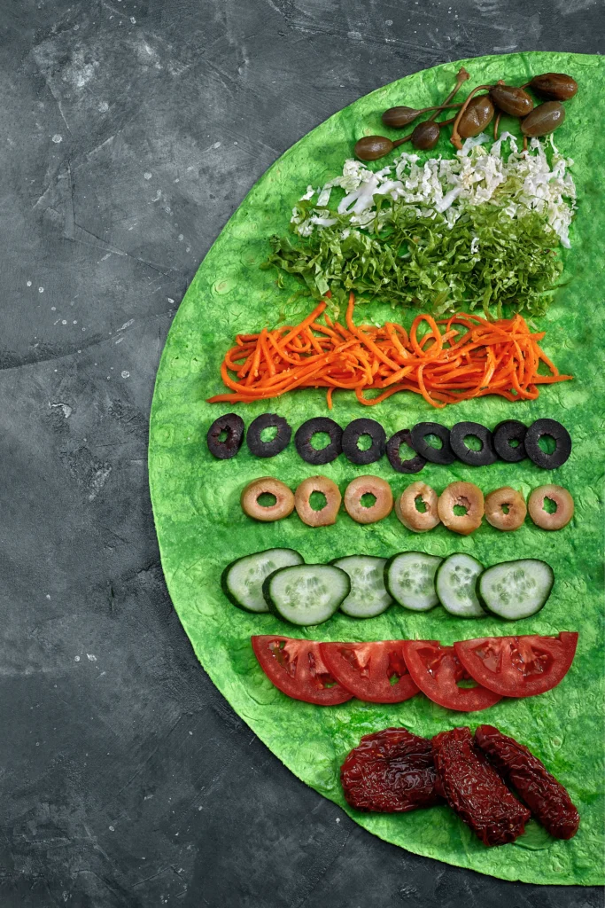Fresh vegetarian lettuce wraps filled with colorful vegetables and tofu, served in crisp green lettuce leaves