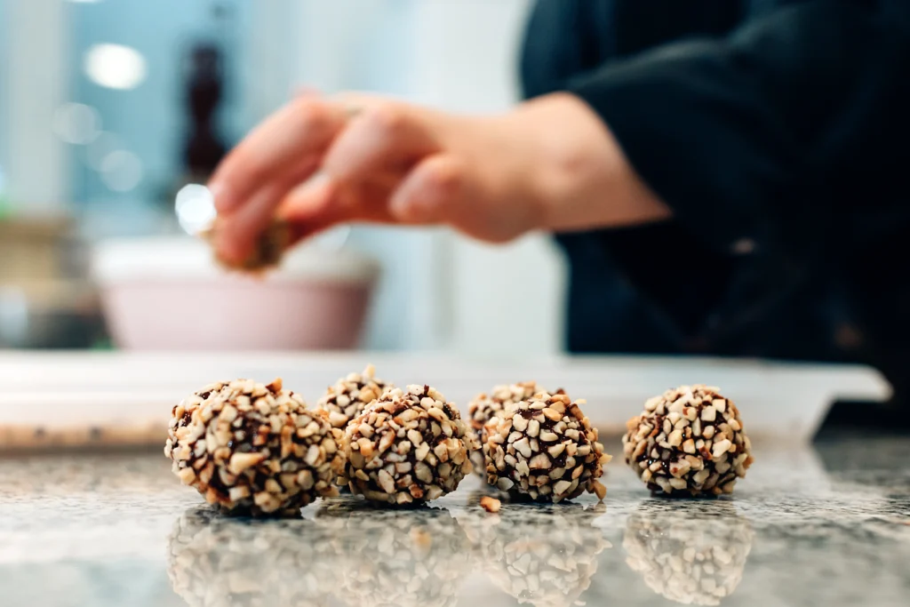 Homemade peanut butter balls coated in chocolate on a plate