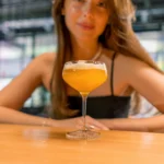 Perfectly balanced Amaretto Sour cocktail in a rocks glass with cherry and orange garnish