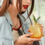 A glass of sweet, fruity Painkiller cocktail with tropical fruit garnish, ready to serve