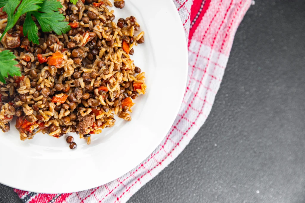 Ground beef and rice recipe served in a bowl with vegetables and herbs, a hearty homemade family dinner