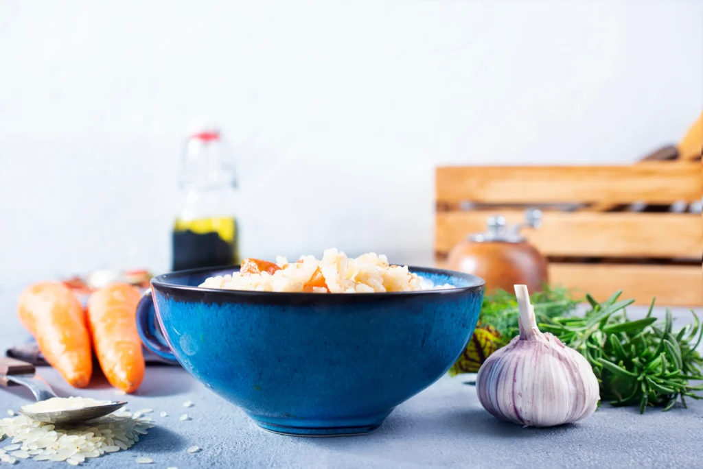 Creamy one-pot chicken gnocchi soup with spinach and carrots in a rustic bowl