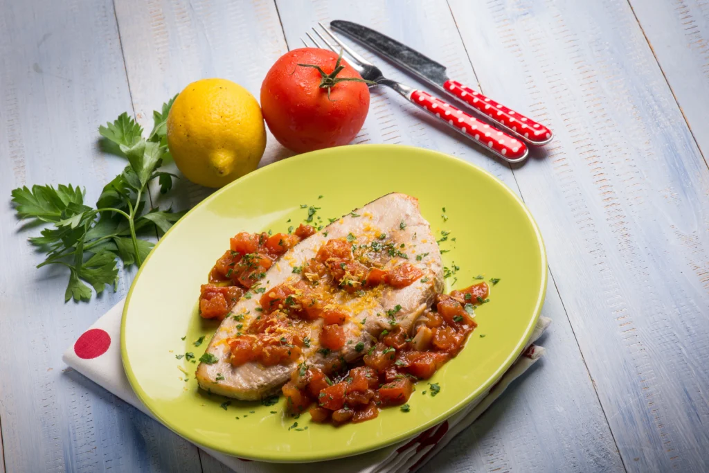 Pan seared red snapper with garlic and lemon served with fresh herbs