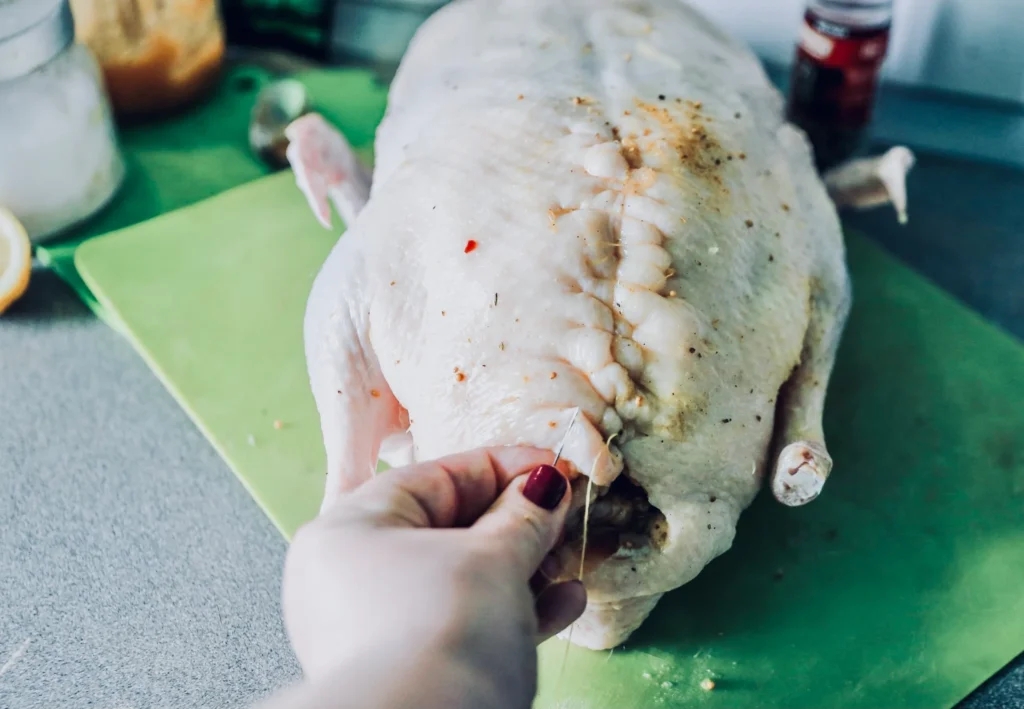 Traditional Peking Duck recipe served with hoisin sauce, thin pancakes, and fresh scallions on a wooden platter