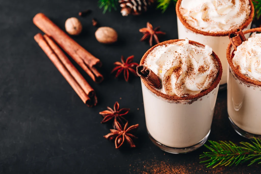Coquito Recipe
Festive Coquito in a glass with cinnamon stick and grated nutmeg, traditional Puerto Rican Christmas drink on a holiday table.