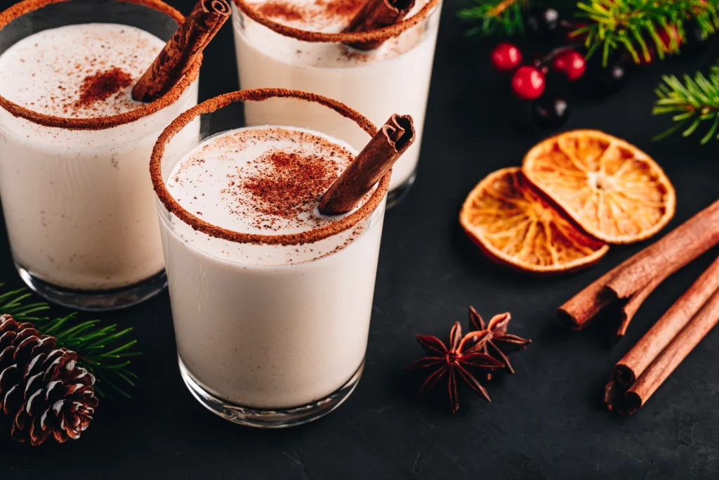 Coquito Recipe
Festive Coquito in a glass with cinnamon stick and grated nutmeg, traditional Puerto Rican Christmas drink on a holiday table.