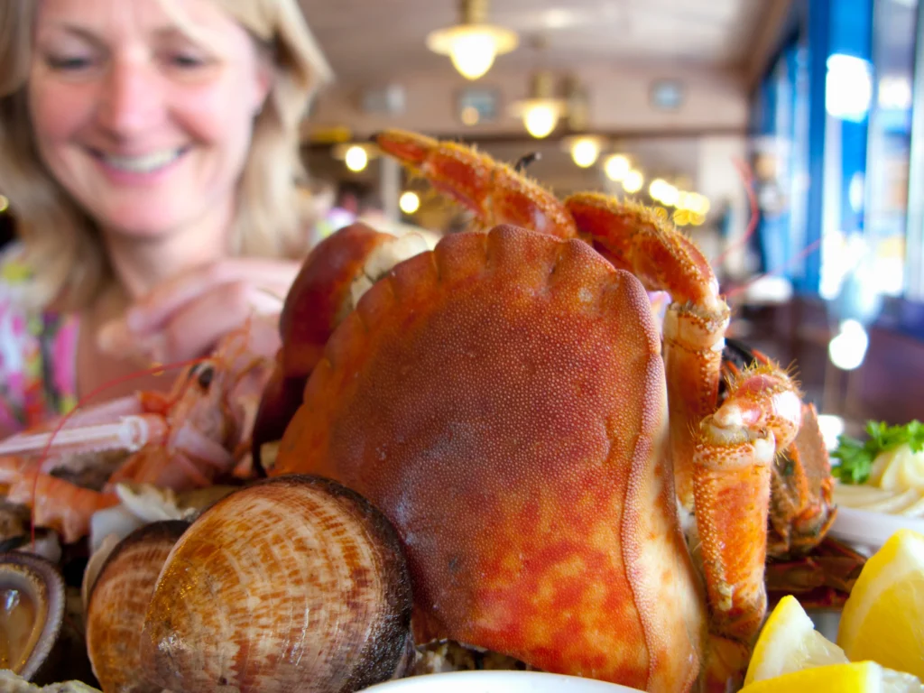 Cajun seafood boil with shrimp, crab legs, corn on the cob, potatoes, and spicy seasoning served on a rustic table
