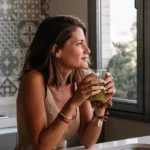 Fresh ginger shot in a small glass with lemon and turmeric for natural morning energy boost