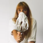 Whipped meringue with glossy stiff peaks in a mixing bowl showing perfect texture for a foolproof meringue recipe.