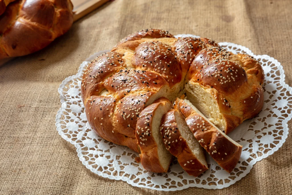 Challah Recipe
Freshly baked traditional challah bread with a golden braided crust on a wooden table for Shabbat dinner