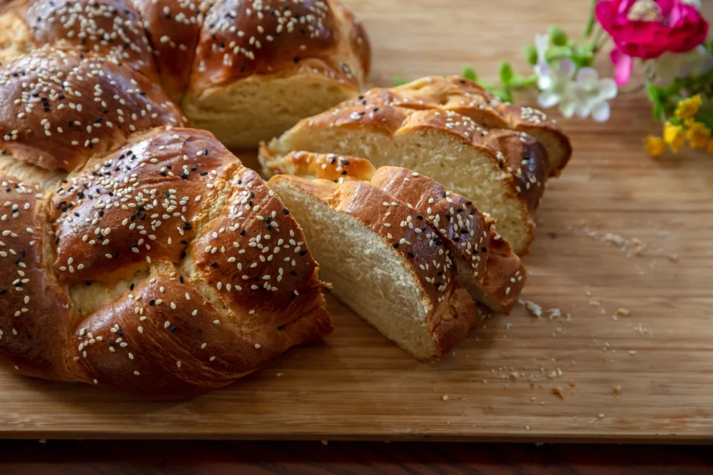 Challah Recipe
Freshly baked traditional challah bread with a golden braided crust on a wooden table for Shabbat dinner