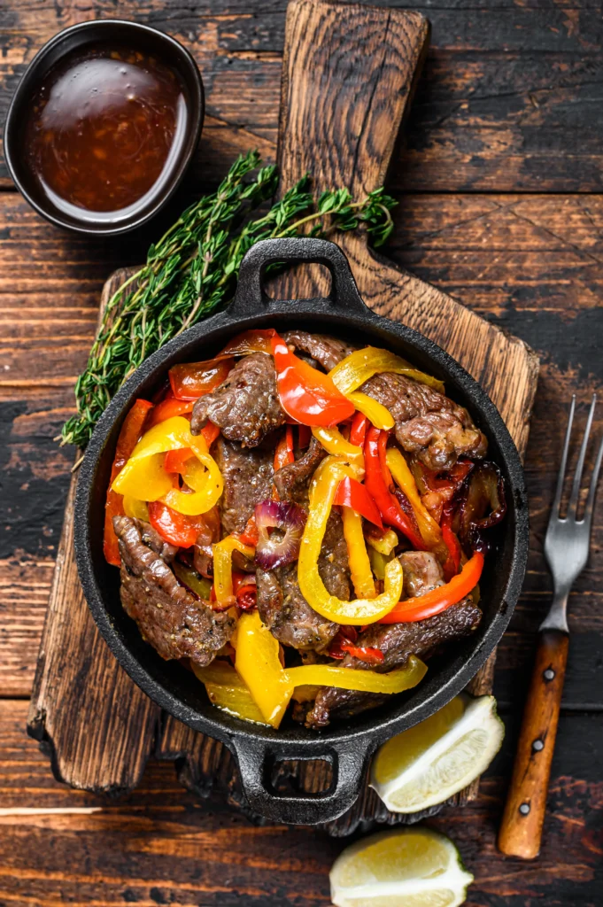 Juicy pepper steak with tender beef strips, colorful bell peppers, and savory sauce in a skillet