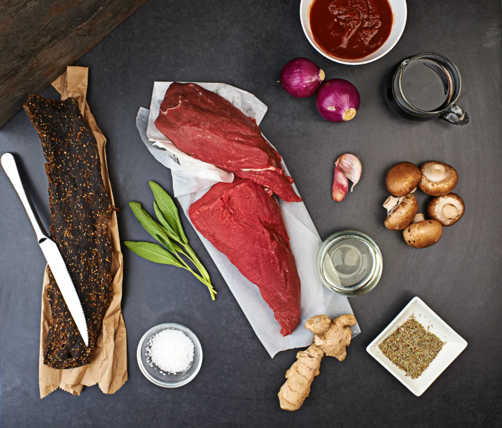 Smoked brisket sliced on a wooden board with a crispy bark and juicy interior, served at a BBQ party