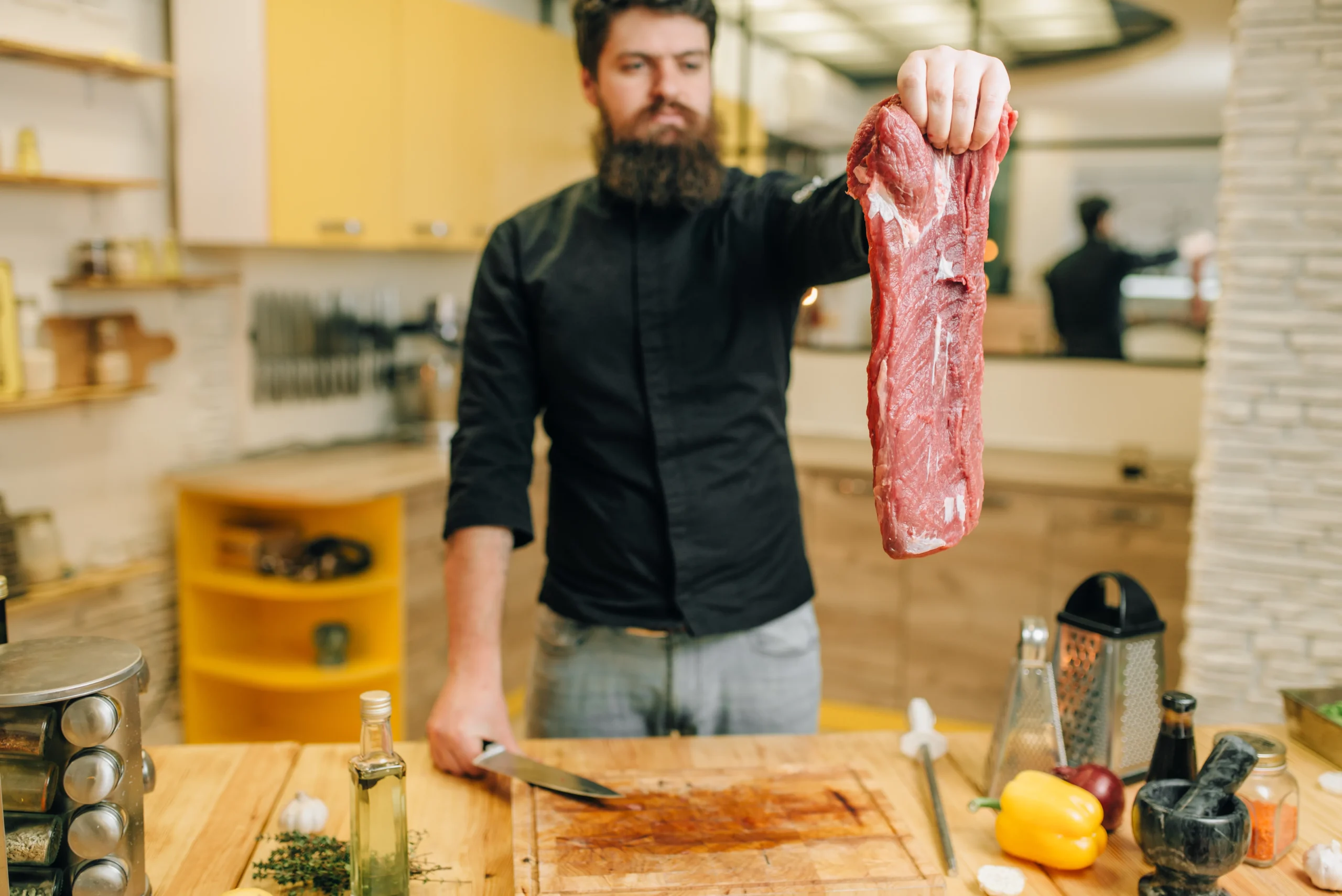 Sliced tender flank steak served on a cutting board with herbs and juices