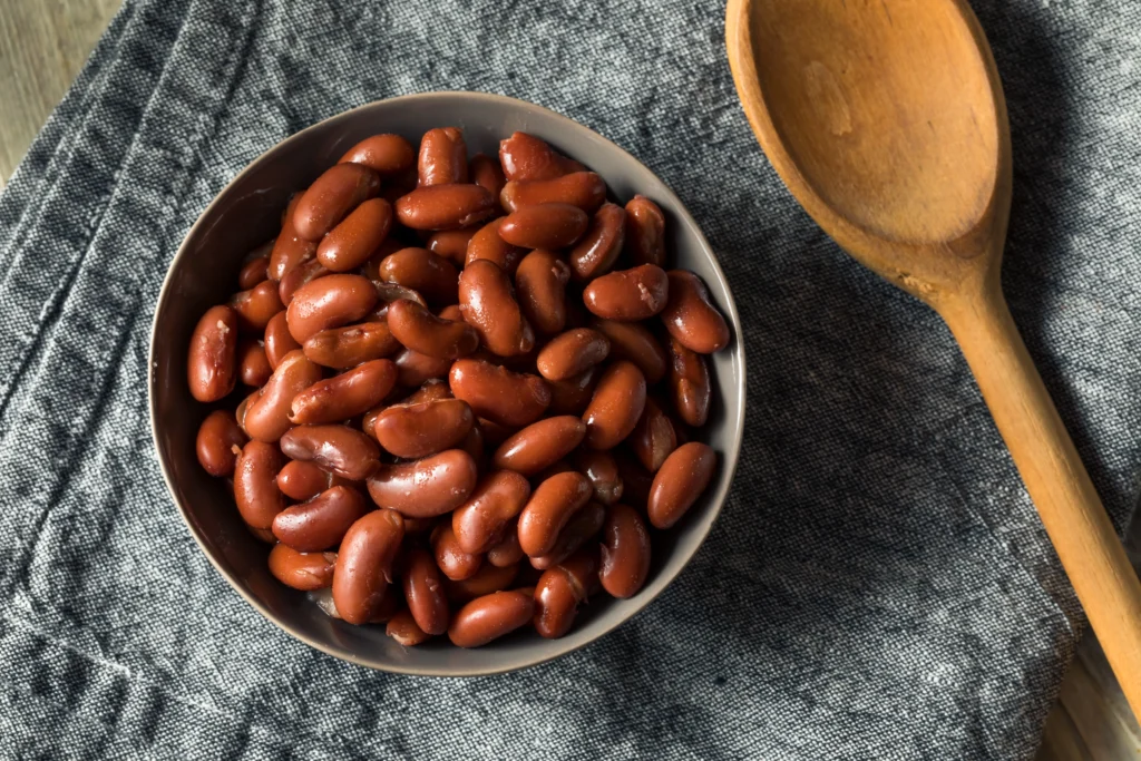 Hearty homemade crockpot chili with beans, peppers, and melted cheese served with cornbread