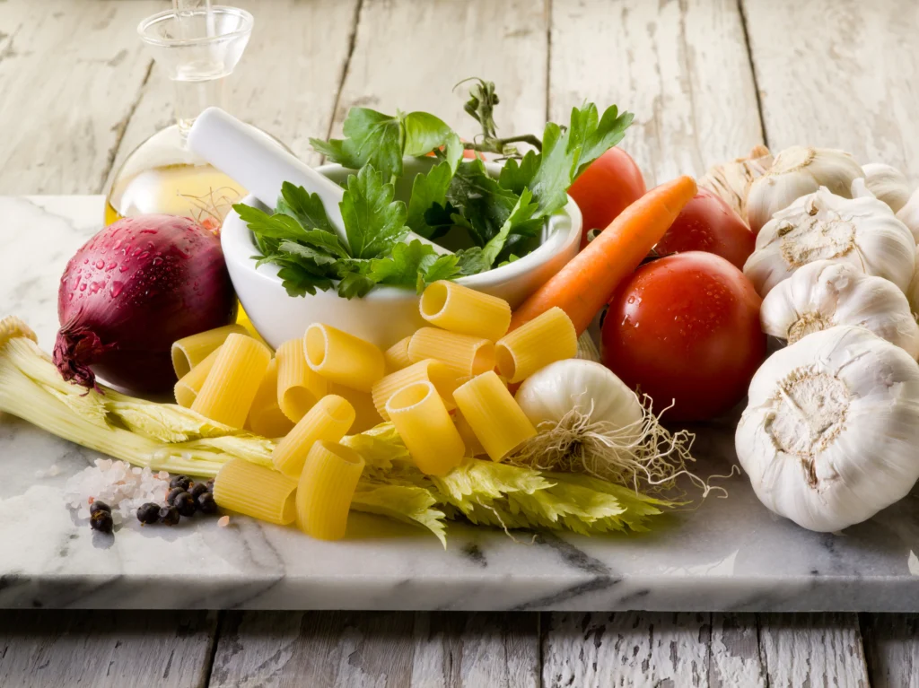 Hearty vegetable minestrone soup with beans, pasta, and fresh herbs in a rustic bowl