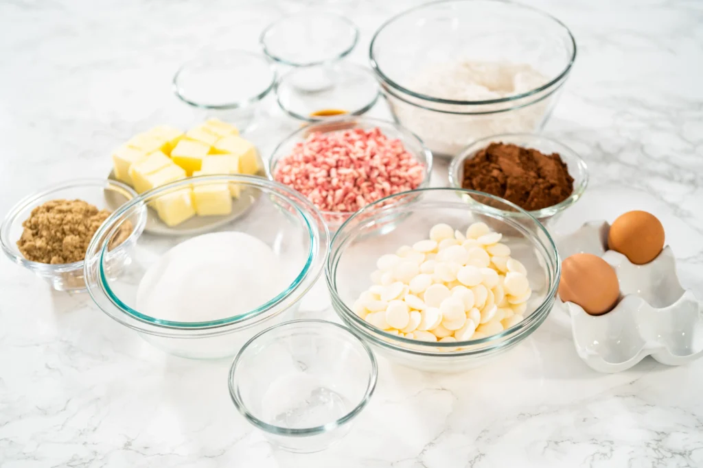 Buttery homemade spritz cookies in festive shapes on a baking tray, freshly baked and golden edges