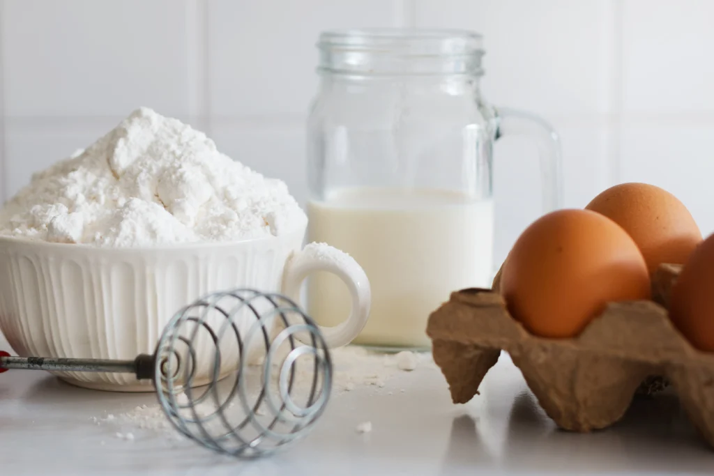 Whipped meringue with glossy stiff peaks in a mixing bowl showing perfect texture for a foolproof meringue recipe.