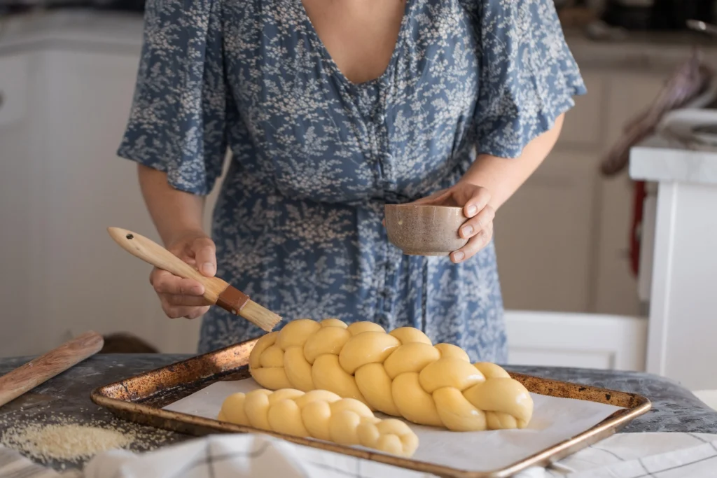 Challah Recipe
Freshly baked traditional challah bread with a golden braided crust on a wooden table for Shabbat dinner