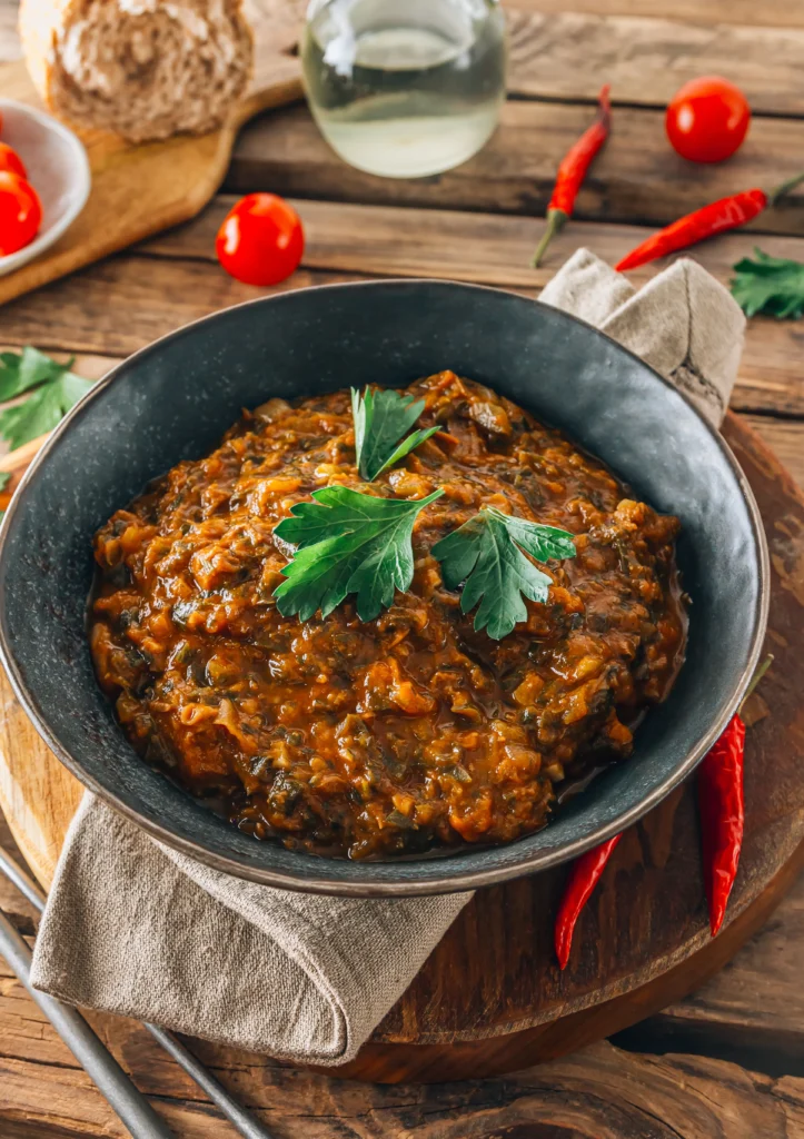 A variety of healthy crockpot meals including vegetable stew, chicken with herbs, and lentil soup served in bowls on a rustic kitchen table.
