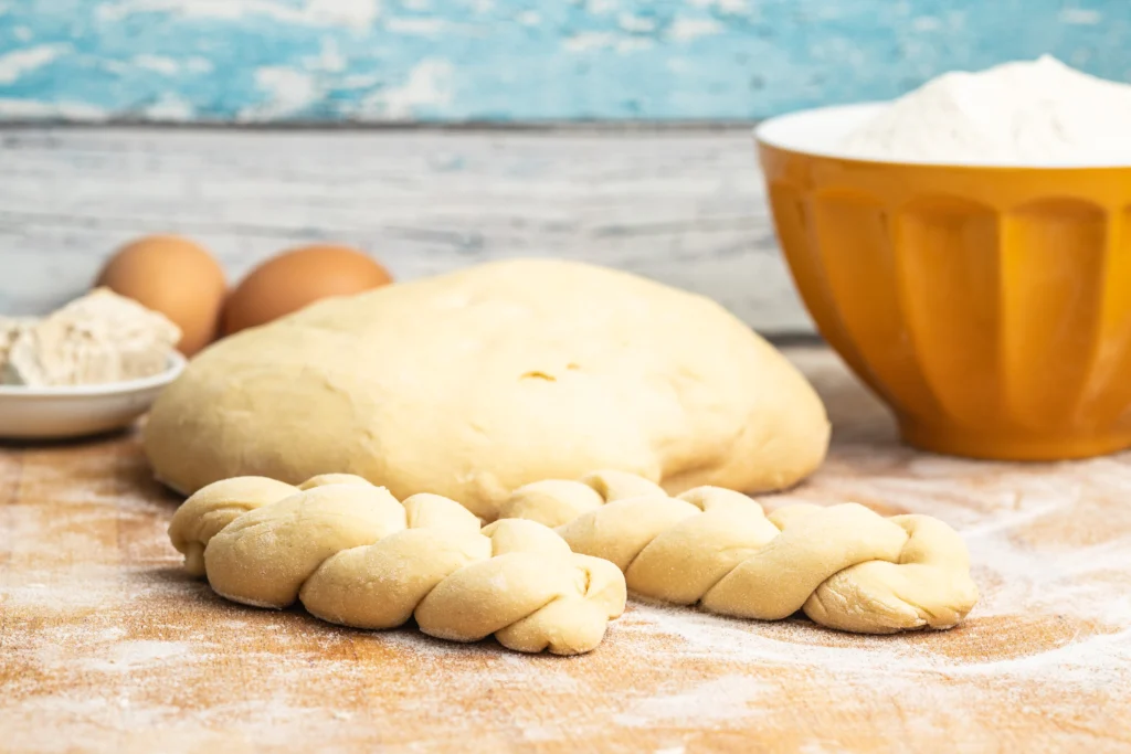 Challah Recipe
Freshly baked traditional challah bread with a golden braided crust on a wooden table for Shabbat dinner