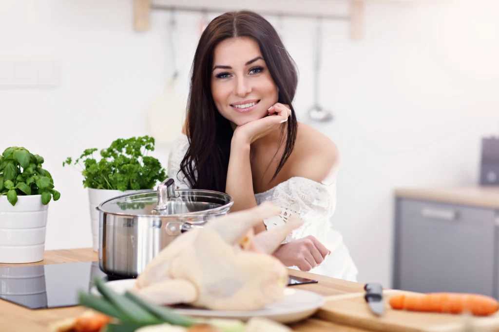 Juicy shredded chicken in a bowl with herbs, showing a tender texture from an easy shredded chicken recipe.
